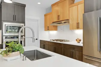 Kitchen and island featuring the microwave, oven and cooktop.