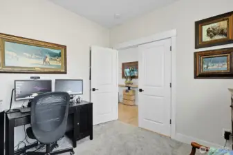 Main floor bedroom with closet could double as an office as shown here.