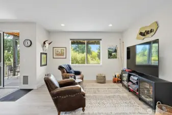 Lower floor family room with access to the lower deck and the backyard.  Great for entertaining with plenty of room to spread out and enjoy.