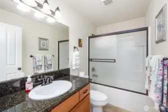 Upstairs full bathroom with plenty of storage and counterspace.