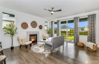 Living room with fireplace, leading to the back yard