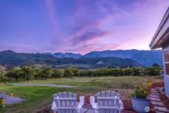 Panoramic Cascade Views: Relax on the expansive half wrap-around deck overlooking lush orchards. The perfect spot for morning coffee or sunset entertaining just minutes from the Bavarian Village.