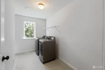 Spacious laundry room is conveniently located upstairs.