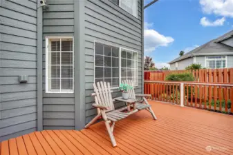 A closer look at the large front deck, perfect for visiting with neighbors or enjoying a steaming cup of coffee before or after a long day away from this oasis.