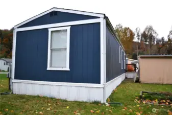 The back end and north side, also showing the back of the shed.