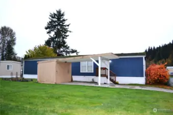 The storage shed provides extra space for your belongings. The lawn in the foreground is maintained by the community.