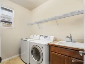 Room for all your necessities on the top shelf in this laundry room.