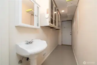 Storage room with sink, leading you to backyard