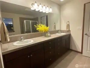 Primary bath with dual sinks and tiled counter tops