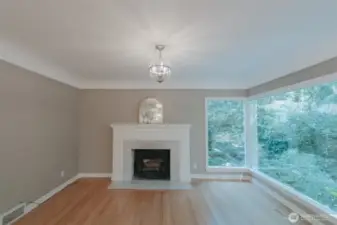 main floor living space, wood burning fireplace and beautiful ceilings with the original cove