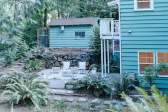 lower level patio space or a private space for a VRBO. Also that is a chicken coop!