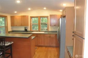 The spacious kitchen is designed for gathering—ideal for preparing meals for a crowd or hosting memorable get-togethers. Featuring an eating bar, a casual dining area just off the kitchen, and a separate formal dining room, this home offers endless options for entertaining and everyday living