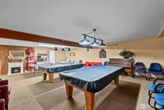 The billiards room has two pool tables and a ping-pong table located on the bottom level of clubhouse.