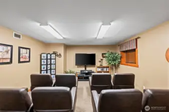 Movie theatre space is located in a corner of the large billiards room.