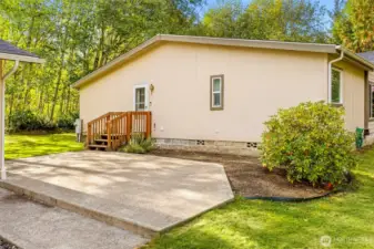 Side entrance and patio area between garage and home