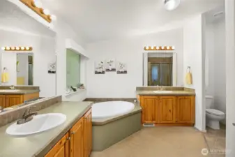 Primary bathroom with garden tub, dual vanities