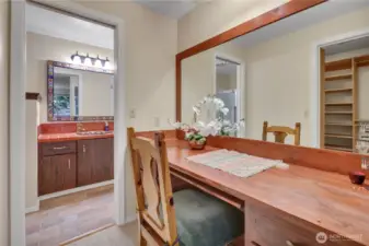 Beautiful built-in desk area between the primary BR and the main bathroom. There's big walk-in closet to the left.