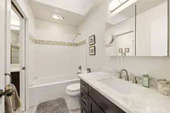 Beautifully updated 5 piece upstairs bathroom, complete with quartz countertops, immersion tub, new fixtures, lighting and tile.
