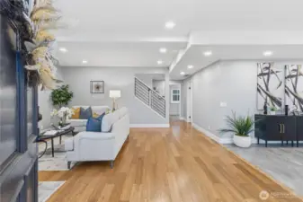 Open concept living with bamboo floors and abundant natural light