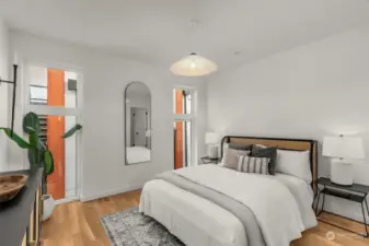 The primary suites occupy the entire upper floor, featuring a pristine bathroom with a walk-in rain shower and a generously sized closet with ready-to-use shelving.