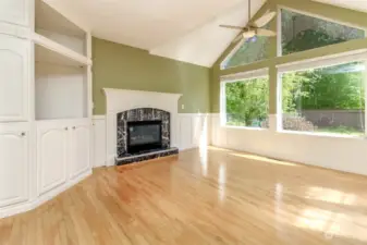 Family Room features gas fireplace, built-in, backyard view & french doors to covered deck