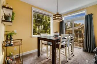 A spacious dining area with a large window and a slider to the balcony.