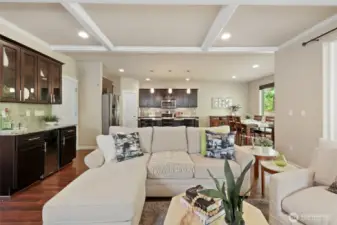 View looking back across the main living space from the fireplace to the kitchen.