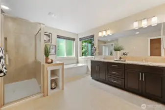 En suite Tiled shower, bathtub and dual vanity.
