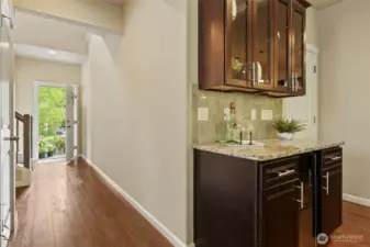 Hallway back to the front door - wide bright hallway & a look at the beverage center.