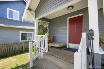 There is a welcoming front porch where one can sit and watch the world go by!