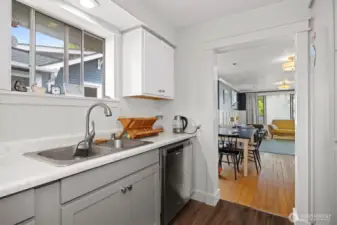 There is a wide open doorway between the dining area and the kitchen.