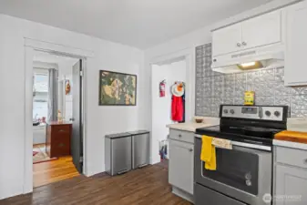Looking toward one of the bedrooms and the laundry room to the right.