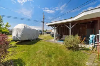 The rear yard has alley access to the carport, currently being used as covered outdoor patio space.