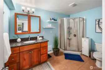 There is a three quarter ensuite bath off of the primary bedroom which includes an enclosed stand-up shower
