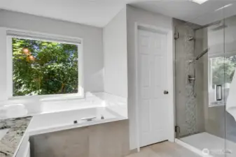 Updated Walk-In shower with beautiful tile & glass work, double shower heads, that include luxurious high volume rain shower head.