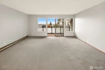 Open view of the living room out to the balcony with views of Puget Sound & Whidbey Island.