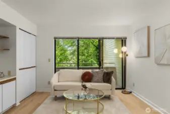 Spacious living room features new LVP light oak flooring.