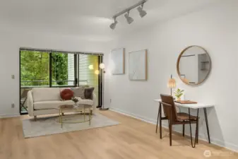 Spacious living room features new LVP light oak flooring.