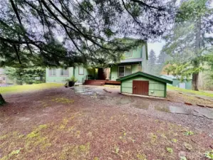 Pump house includes the filtration system.  House stands regally with flagstone pavers leading from the driveway to the house and detached garage.  Shop tucked behind the house and garage.