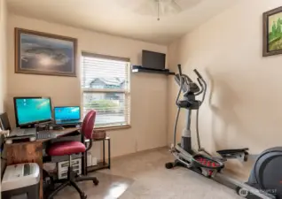 A third bedroom is currently used as an office and exercise space.