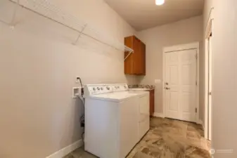 Laundry room with deep sink, leading out to the spacious 3-car garage