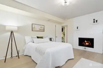 Lower level bedroom with fireplace.