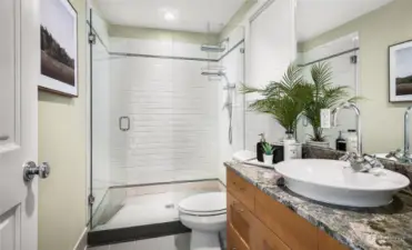 The primary bathroom with quartz countertops and vessel sink.