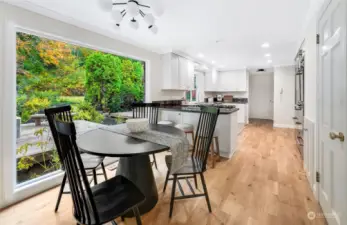 Another view of the everyday dining, inviting kitchen, and new hardwood floors.