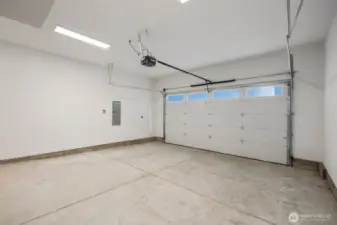 Generous 2 Car Garage w/ Electric Charger Outlet.