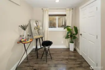 Extra finished room with laminate flooring could be used for crafts, den, or play room.
