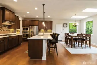 Host with ease in this expansive kitchen and dining area, filled with natural light and open flow.