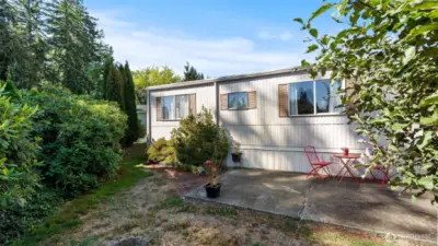 Side yard includes a patio area, perfect for potted plants