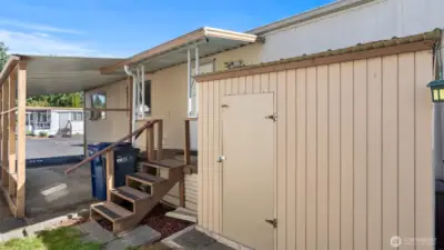 Storage shed has space for your yard tools.