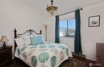 Bedroom with vaulted ceiling.